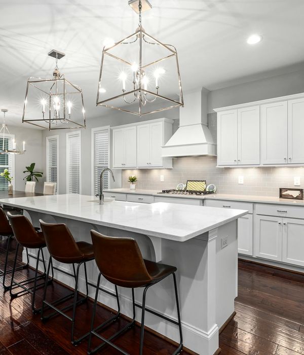 Bright luxury kitchen with white cabinets marble countertops and island