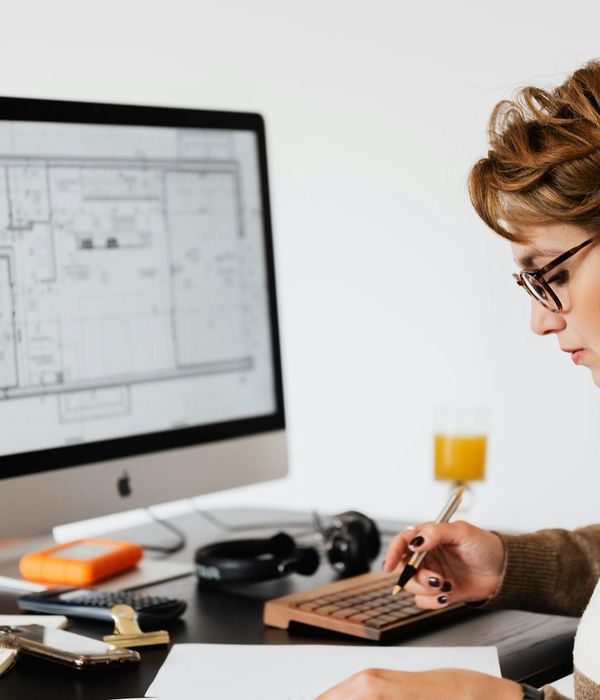 Professional woman architect wearing glasses examining interior design plans