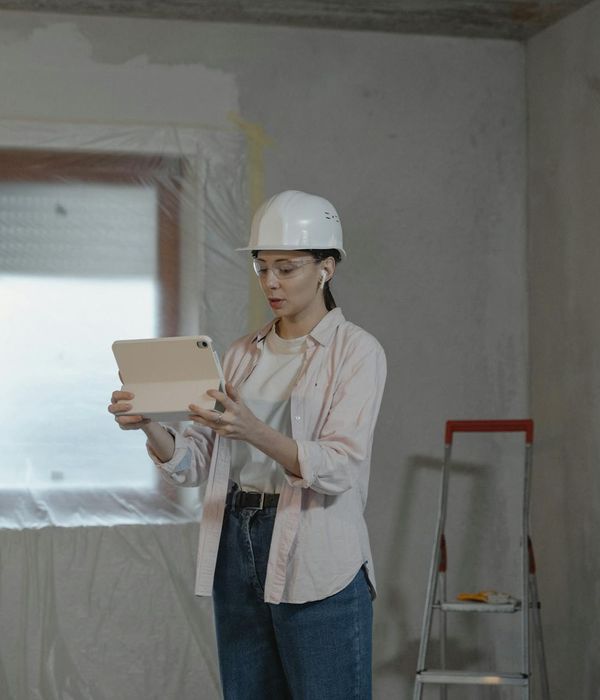 Professional woman manager using tablet coordinating renovation project
